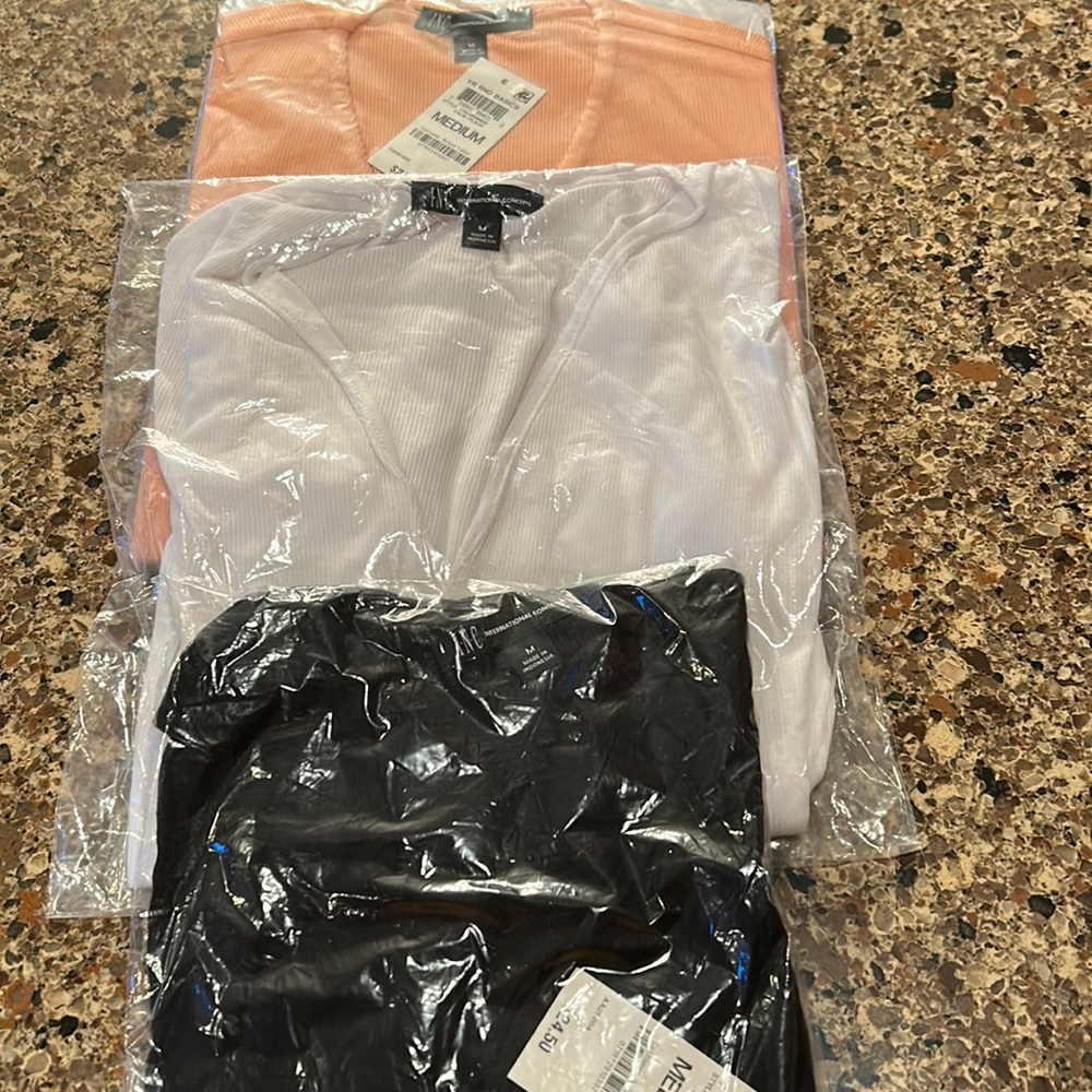 Set of 3 Brand new International Concept size medium V neck short sleeve shirts.